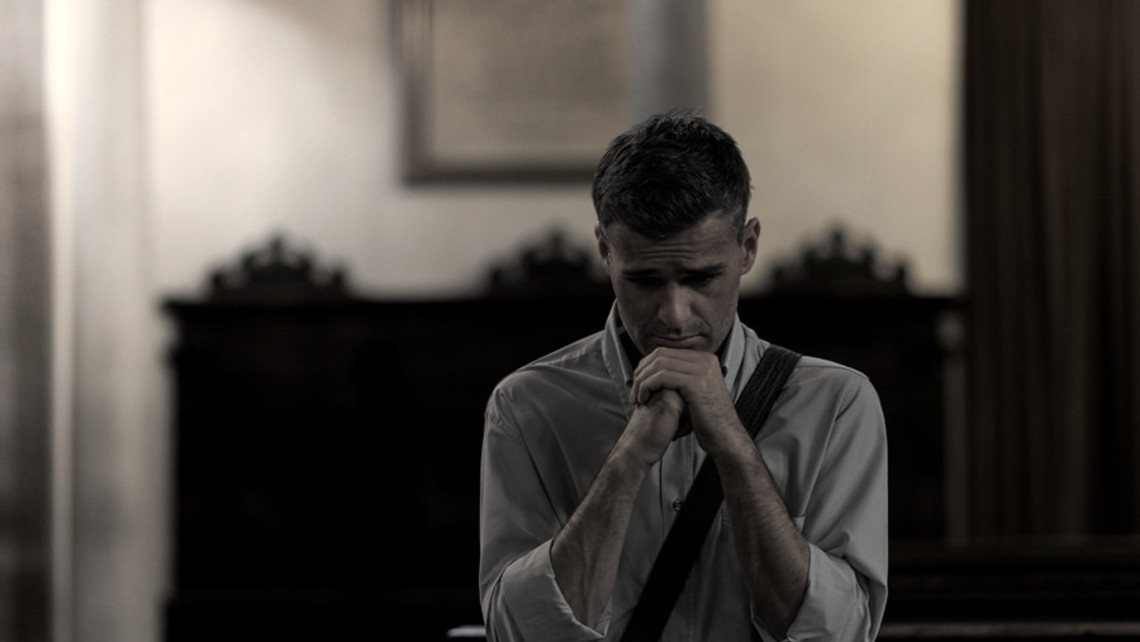 Man Praying In Church